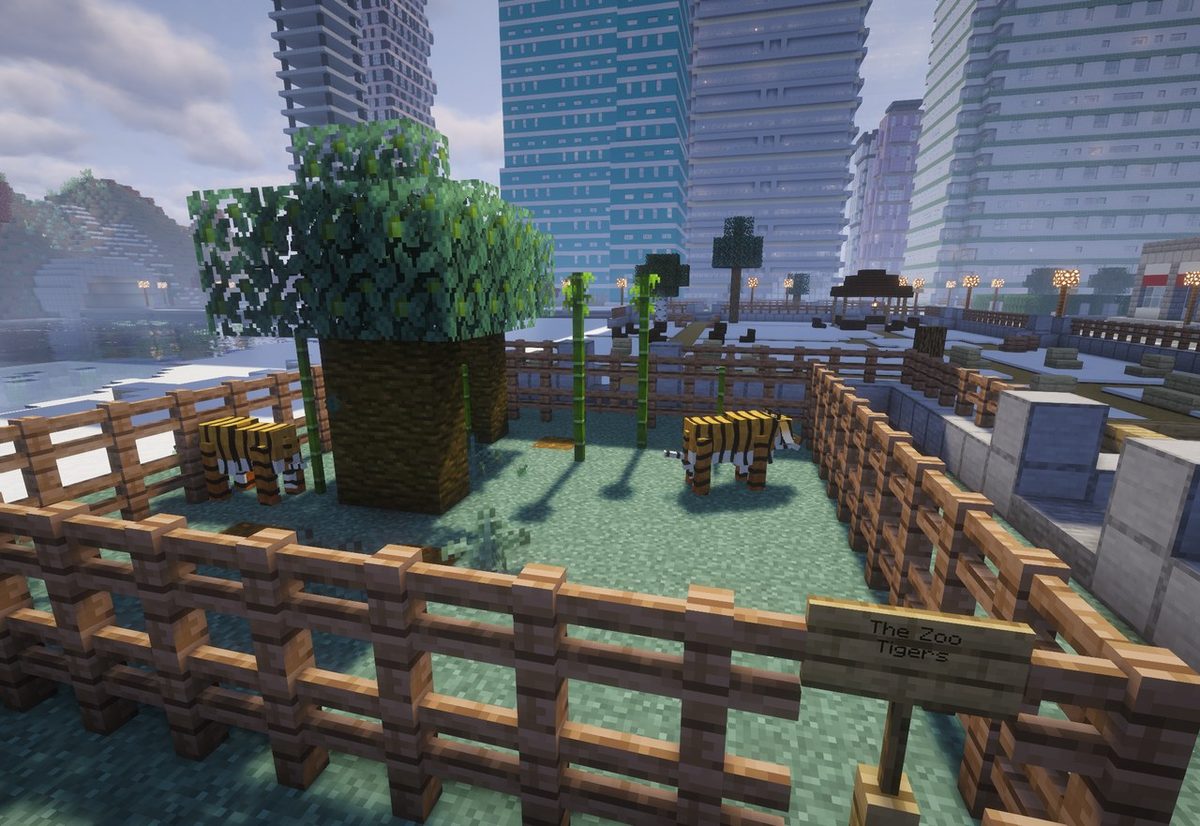 A CityWorld zoo pen signed The Zoo Tigers, two tigers inside, the city's towers behind